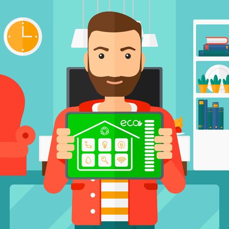A hipster man with the beard holding a tablet computer with smart home application on a screen on the background of modern  living room vector flat design illustration. Square layout.のイラスト素材