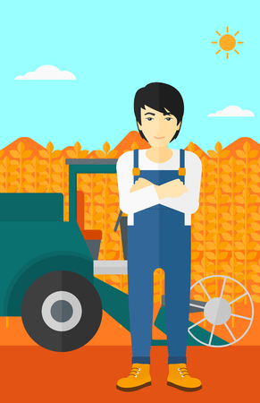 An asian man standing on the background of combine harvesting wheat vector flat design illustration. Vertical layout.のイラスト素材