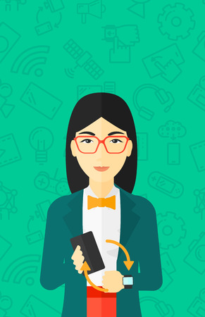 An asian woman holding a smartphone and looking at her smart watch on a green background with technology icons vector flat design illustration. Vertical layout.のイラスト素材