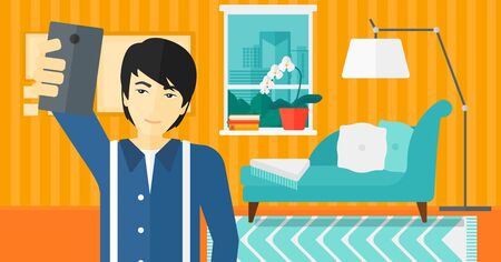 An asian man making selfie on the background of living room vector flat design illustration. Horizontal layout.のイラスト素材