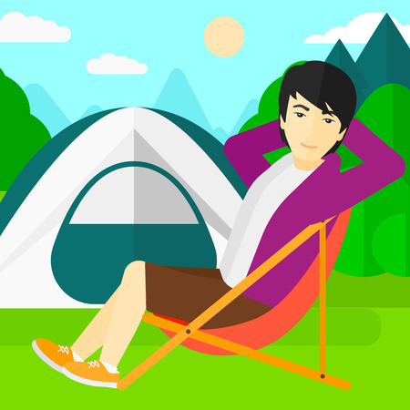 An asian man sitting in a folding chair on the background of camping site with tent vector flat design illustration. Square layout.のイラスト素材