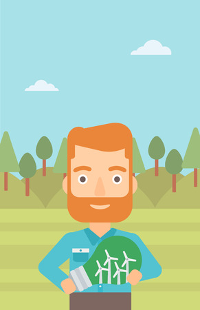 A hipster man with the beard standing on the background of green forest and holding in hands a big light bulb with small wind turbines inside vector flat design illustration. Vertical layout.のイラスト素材