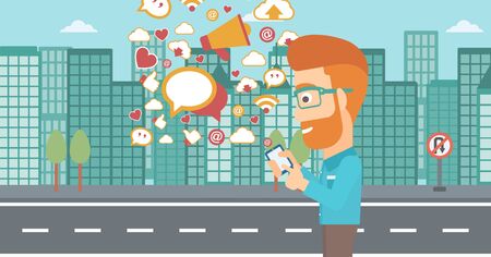 A hipster man with the beard using smartphone with lots of social media application icons flying out on a city background vector flat design illustration . Horizontal layout.のイラスト素材