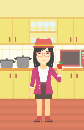 An asian young woman holding an apple in the kitchen. Young woman eating an apple in the kitchen. Woman with an apple at home. Vector flat design illustration. Vertical layout.のイラスト素材
