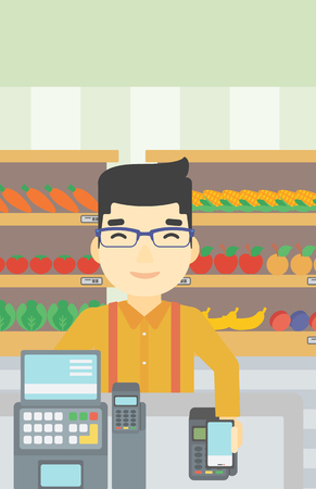An asian young man paying wireless with his smartphone at the supermarket checkout . Male customer making payment for purchase with smartphone. Vector flat design illustration. Vertical layout.のイラスト素材