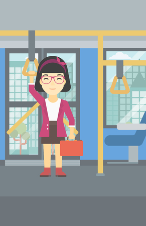 An asian woman traveling by public transport. Young woman standing inside public transport. Woman traveling by passenger bus or subway. Vector flat design illustration. Vertical layout.のイラスト素材