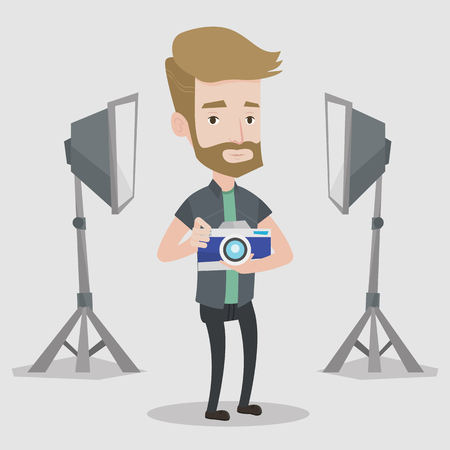 A hipster photographer with the beard holding a camera in photo studio. Photographer using professional camera in the studio. Young man taking a photo. Vector flat design illustration. Square layout.のイラスト素材