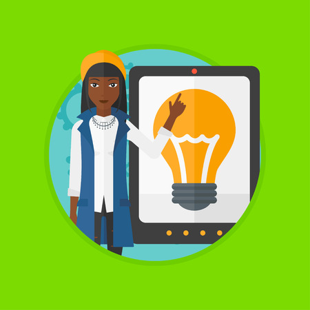 African-american woman pointing at a big tablet computer. Woman standing near a big tablet computer with a light bulb on a screen. Vector flat design illustration in the circle isolated on background.のイラスト素材
