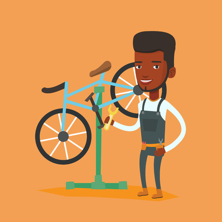 African bicycle mechanic working in repair shop.のイラスト素材