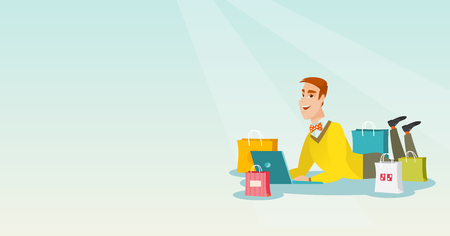 Young caucasian man using laptop for online shopping. Smiling man lying with a laptop and shopping bags around him. Happy man doing online shopping. Vector flat design illustration. Horizontal layout.のイラスト素材