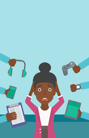 An african-american woman in despair and many hands with gadgets around her. Woman surrounded with gadgets. Woman using many electronic gadgets. Vector flat design illustration. Vertical layout.のイラスト素材
