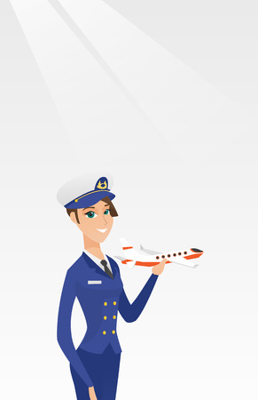 Young caucasian airline pilot holding the model of airplane in hand. Cheerful female airline pilot in uniform. Smiling pilot with the model of airplane. Vector cartoon illustration. Vertical layout.のイラスト素材