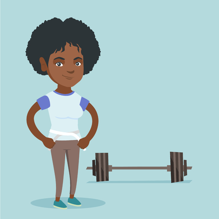 Young african-american woman measuring her waistline with a tape. Happy woman standing next to the barbell and holding a centimeter tape on a waistline.のイラスト素材
