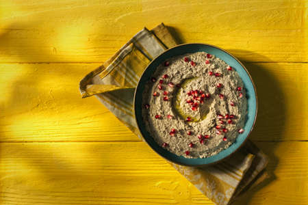 Baba ganoush or mutabal, Middle Eastern eggplant dip sauce garnished with pomegranate seeds, served...
