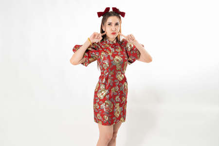 Happy Asian woman wearing traditional cheongsam qipao dress isolated on White background. Happy Chinese new year Women with Happy Expression Conceptの写真素材