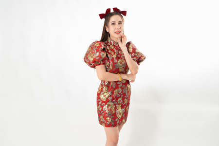 Happy Asian woman wearing traditional cheongsam qipao dress isolated on White background. Happy Chinese new year Women with Happy Expression Conceptの写真素材