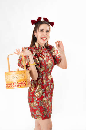 Chinese New Year concept, Woman holding a basket of food ,meaning to be happy healthy and wealthy year, Chinese New Year Celebration Conceptの写真素材