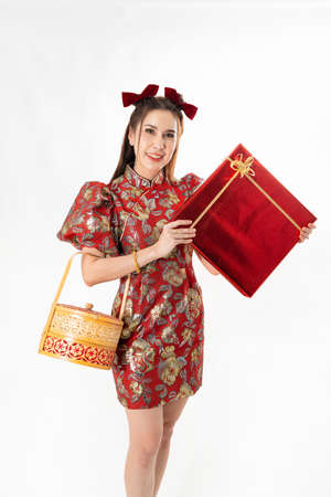 Chinese New Year concept, Woman holding a basket of food and red basket ,meaning to be happy healthy and wealthy year, Chinese New Year Celebration Conceptの写真素材