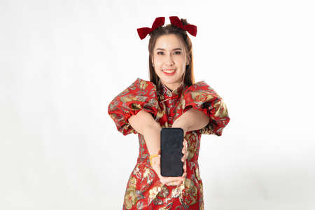 Happy chinese new year. excited young Woman showing blank smart phone screenの写真素材