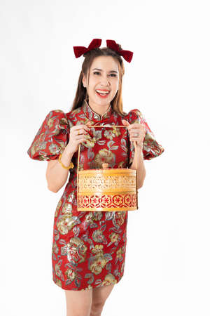 Chinese New Year concept, Woman holding a basket of food ,meaning to be happy healthy and wealthy year, Chinese New Year Celebration Conceptの写真素材