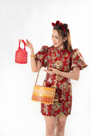 Chinese New Year concept, Woman holding a basket of food and red basket ,meaning to be happy healthy and wealthy year, Chinese New Year Celebration Conceptの写真素材