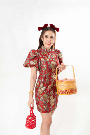 Chinese New Year concept, Woman holding a basket of food and red basket ,meaning to be happy healthy and wealthy year, Chinese New Year Celebration Conceptの写真素材