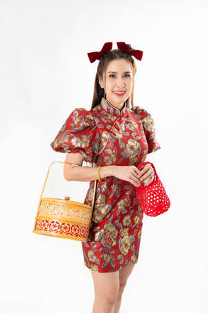 Chinese New Year concept, Woman holding a basket of food and red basket ,meaning to be happy healthy and wealthy year, Chinese New Year Celebration Conceptの写真素材