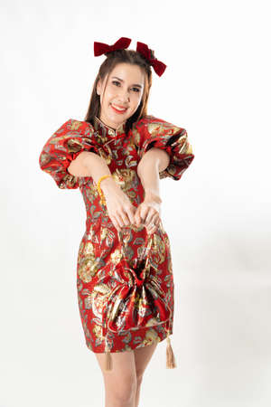 Attractive beautiful Young Asian woman in traditional red cheongsam dressing Chinese for Chinese new year in white isolated studio backgroundの写真素材