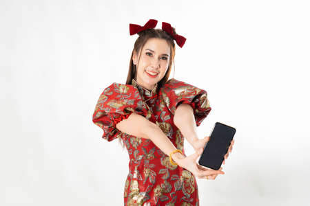 Happy chinese new year. excited young Woman showing blank smart phone screenの写真素材