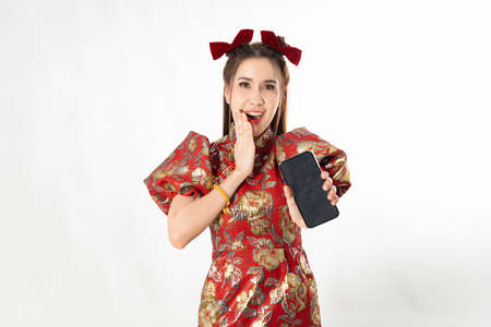 Happy chinese new year. excited young Woman showing blank smart phone screenの写真素材