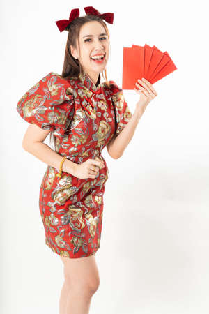 beauty woman wear cheongsam and take Red envelopes in chinese new yearの写真素材