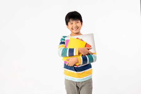 Portrait of Happy asian boy with laptop and books isolated on white background, Education and...