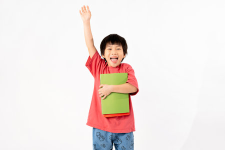 Portrait of Happy asian boy with books isolated on white background, Education and learning with technology conceptの写真素材