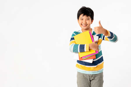Portrait of Happy asian boy with laptop and books isolated on white background, Education and learning with technology conceptの写真素材