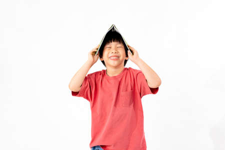 Portrait of Happy asian boy with books isolated on white background, Education and learning with technology conceptの写真素材