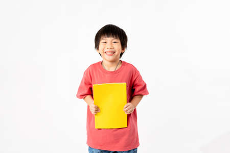 Portrait of Happy asian boy with books isolated on white background, Education and learning with technology conceptの写真素材