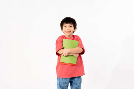 Portrait of Happy asian boy with books isolated on white background, Education and learning with technology conceptの写真素材