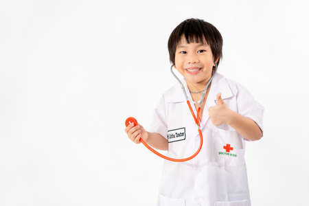 Portrait of Young Asian Boy Dressing to be Doctor Isolate on White Background with Copy space, Education Conceptの写真素材