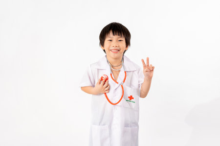 Portrait of Young Asian Boy Dressing to be Doctor Isolate on White Background with Copy space, Education Conceptの写真素材