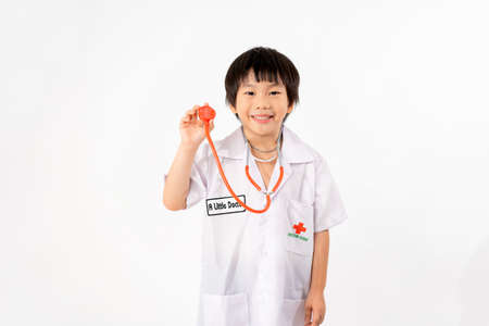 Portrait of Young Asian Boy Dressing to be Doctor Isolate on White Background with Copy space, Education Conceptの写真素材