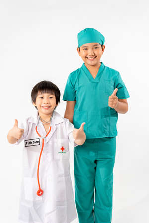 Portrait of Young Asian Boy Dressing to be Doctor Isolate on White Background with Copy space, Education Conceptの写真素材