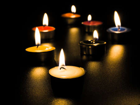 concept of mourning the dead from the corona virus represented by warm candles,COVID-19. Selective...