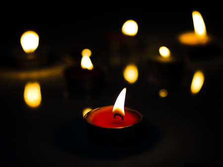 concept of mourning the dead from the corona virus represented by warm candles,COVID-19. Selective Focusの写真素材