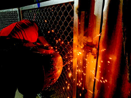 welder connects metal parts to complex structures using electric welding.Selective Focus