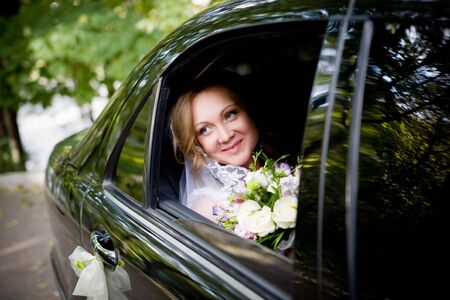 On the image there is bride. She is in car.の写真素材