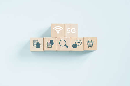 wifi and 5G sign on internet activities symbol on wooden cube blocks for communications, customer persona, social media, personal lifestyle, technology conceptの写真素材