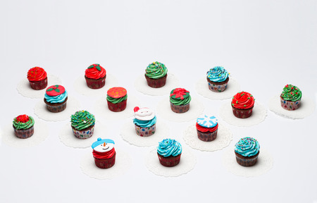 A lot of tasty cupcakes with sprinkles, chocolate. の写真素材