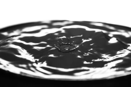 Macro water drop on a black background and circles on itの写真素材