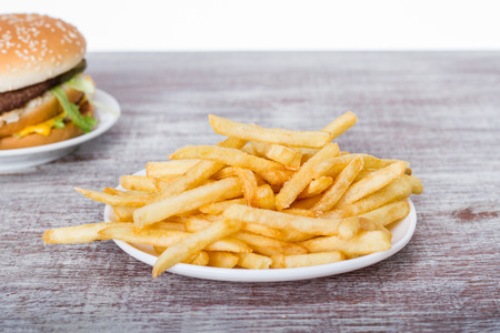Fast food on wood board. French fries