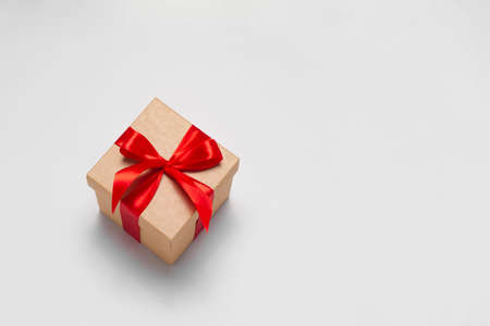 Vintage craft gift box with red ribbon as a presenf for Christmas, new year, mothers day,...